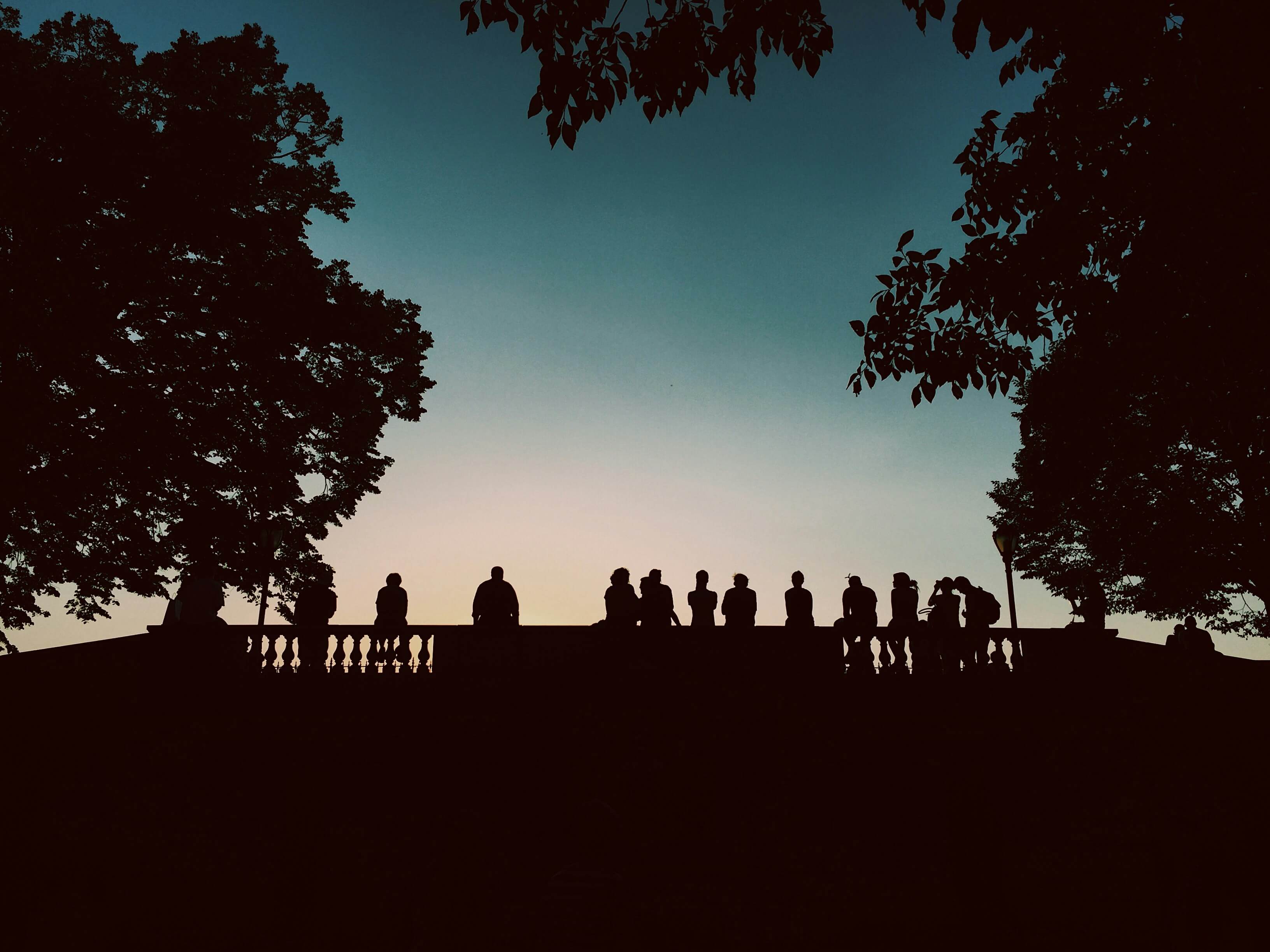 People gathered outside at dusk
